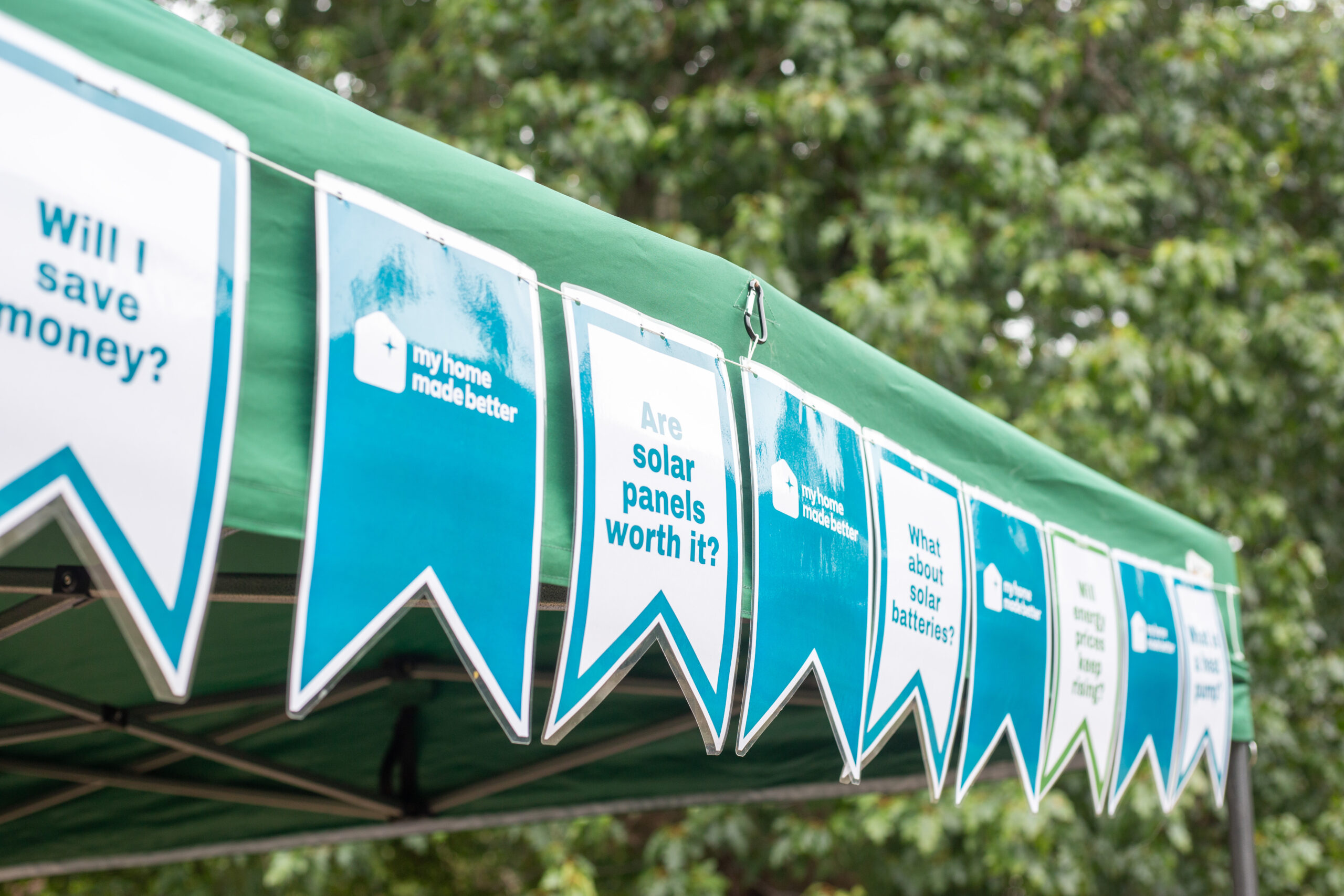 Bunting on the front of a tent for My Home Made Better logos.